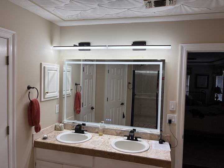 Double vanity with backlit mirror and two light bars